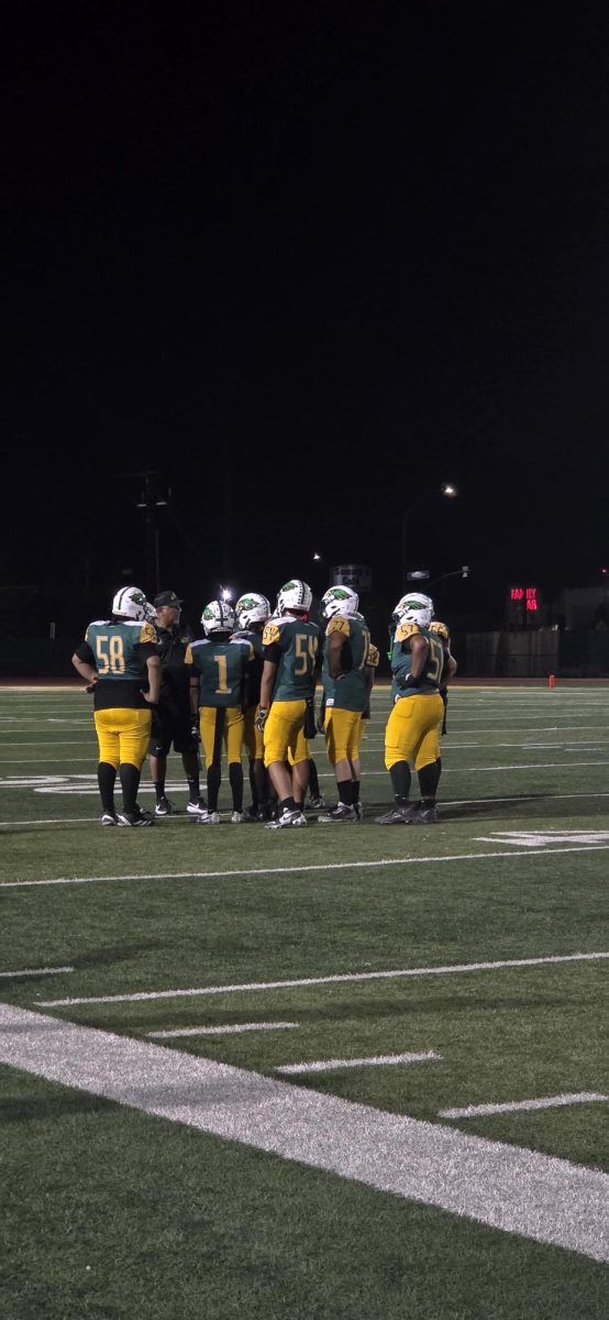 Ike athletes huddling up in between plays.
