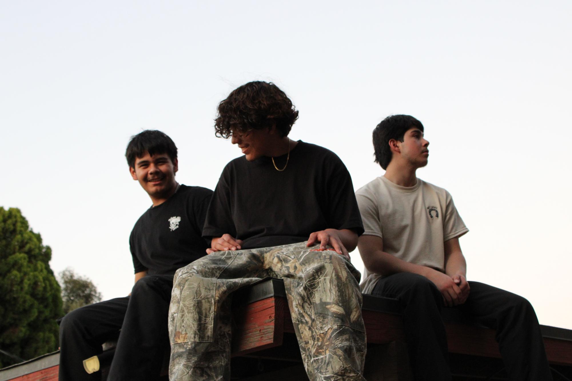 Ryan and Eddie laugh as they try to compose themselves for their headshot while Anthony has already regained his composure.