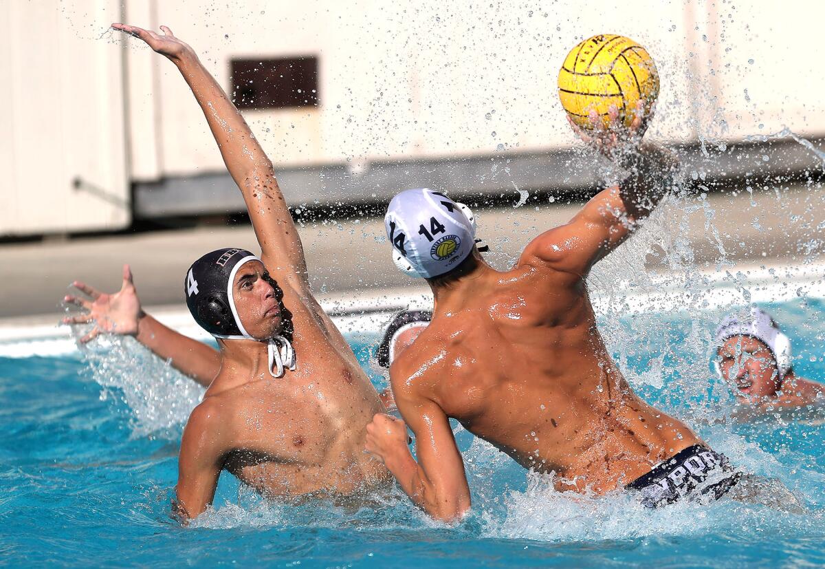 Don Leach All Rights Reserved
A water polo player uses his leverage to make a contested shot on goal in front of a defender.