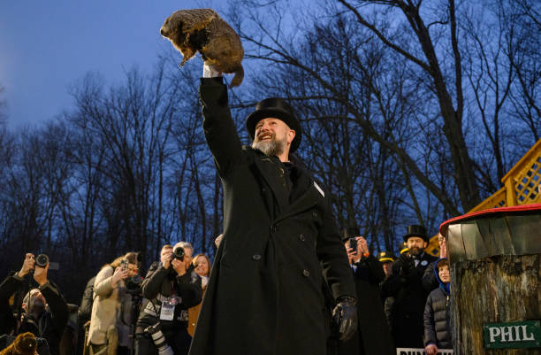 PUNXSUTAWNEY, PA - FEBRUARY 2: Groundhog handler AJ Dereume holds Punxsutawney Phil after he did not see his shadow predicting an early Spring during the 138th annual Groundhog Day festivities on Friday February 2, 2024 in Punxsutawney, Pennsylvania. Groundhog Day is a popular tradition in the United States and Canada. Over 40,000 people spent a night of revelry awaiting the sunrise and the groundhog's exit from his winter den. If Punxsutawney Phil sees his shadow he regards it as an omen of six more weeks of bad weather and returns to his den. Early spring arrives if he does not see his shadow, causing Phil to remain above ground. (Photo by Jeff Swensen/Getty Images)