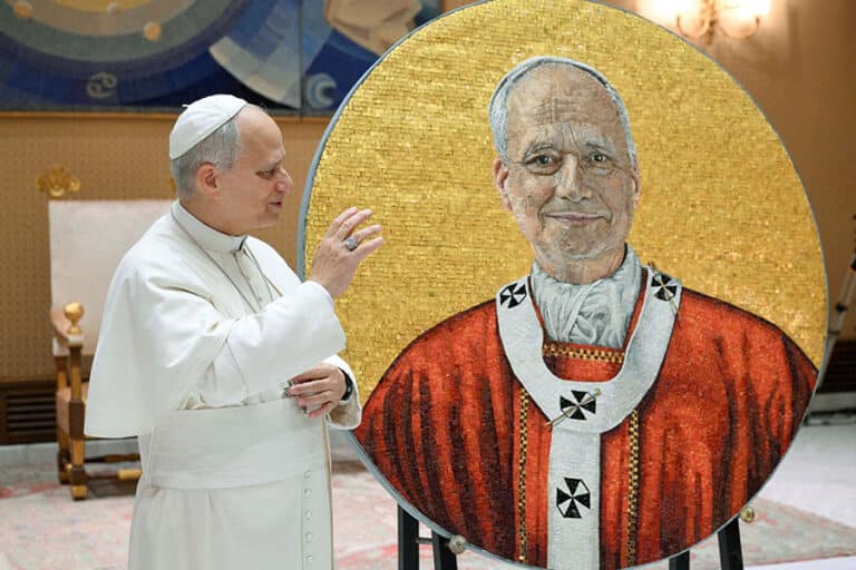 Pope Leo XIV gives a blessing as he stands next to a round mosaic featuring his portrait at the Vatican Jan. 14, 2026. The mosaic will be hung within Rome's Basilica of St. Paul Outside the Walls. (OSV News photo/Simone Risoluti, Vatican Media)