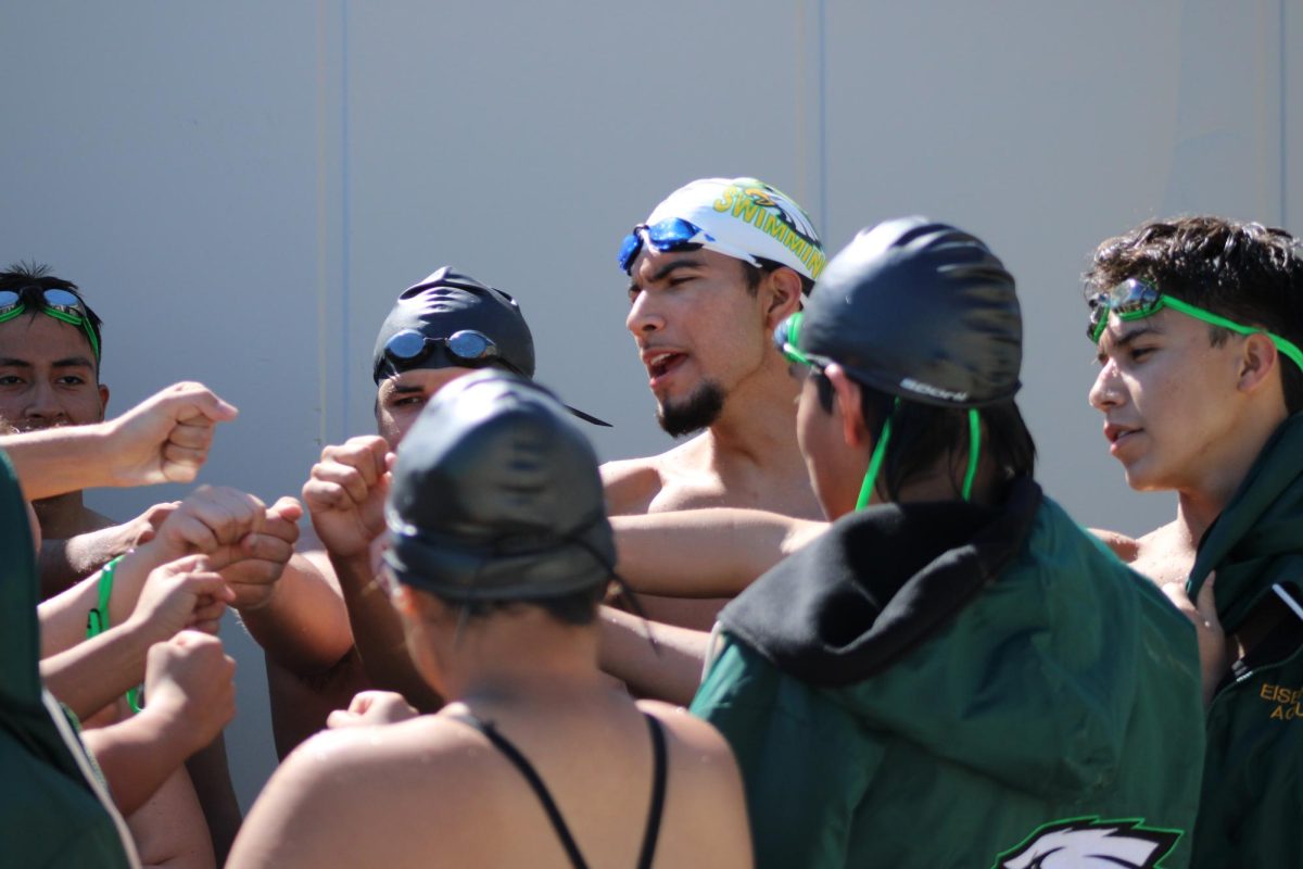 The Eisenhower swim team shouts their “Ike” before heading into the meet.